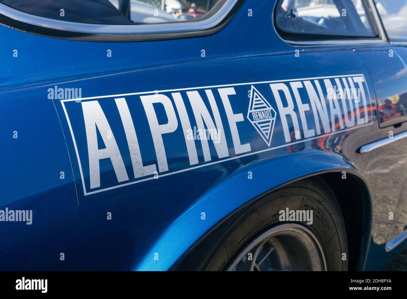 Close up detail of the rear side and wheel arch of a blue 1973 Alpine A110 1600 Si sports coupe, showing the Alpine Renault logo Stock Photo