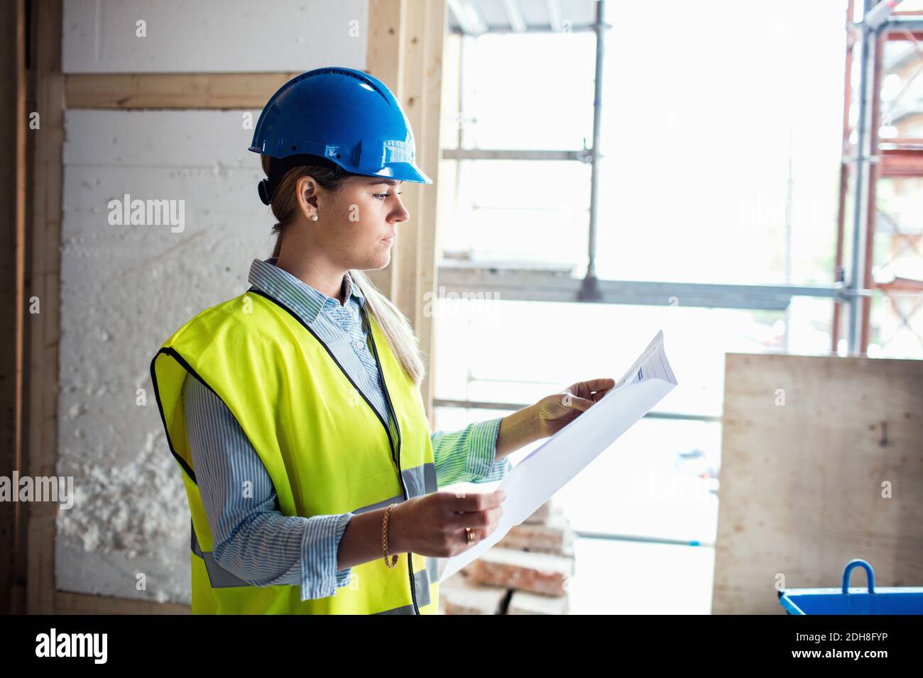 Confident female manual worker at construction site Stock Photo