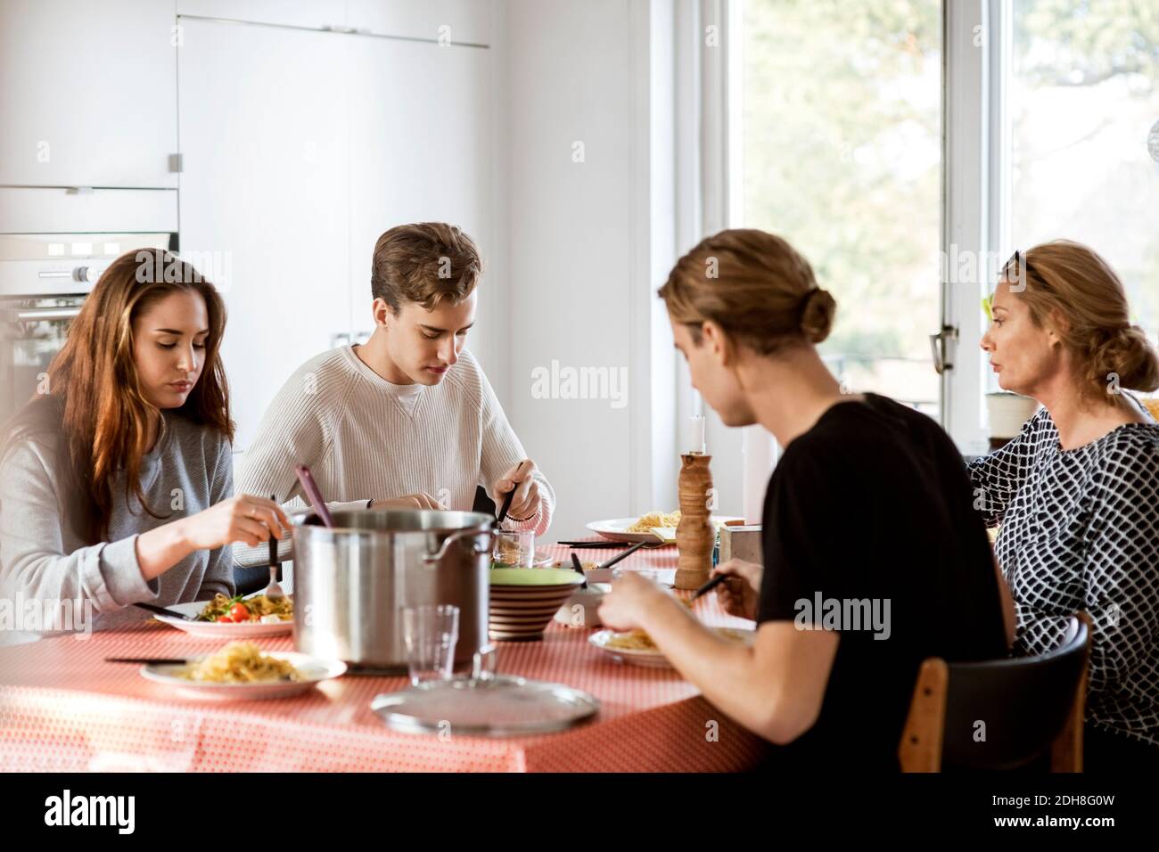 Having Table Family having meal at dining table Stock Photo - Alamy