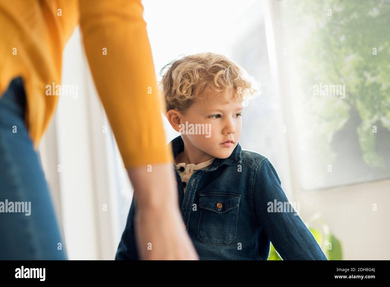 Midsection of girl with brother at home Stock Photo