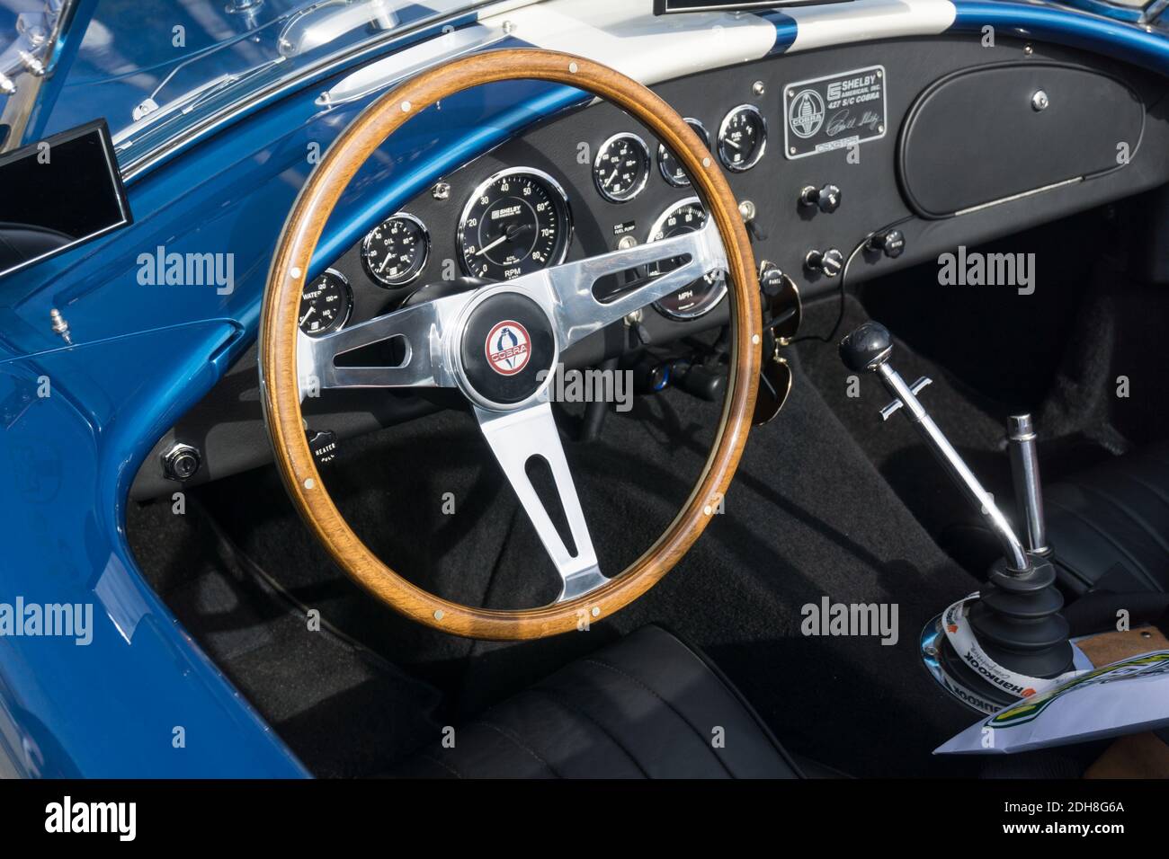 Close up detail of the interior, dashboard and steering wheel of a blue  Shelby AC Cobra open top sports car Stock Photo - Alamy