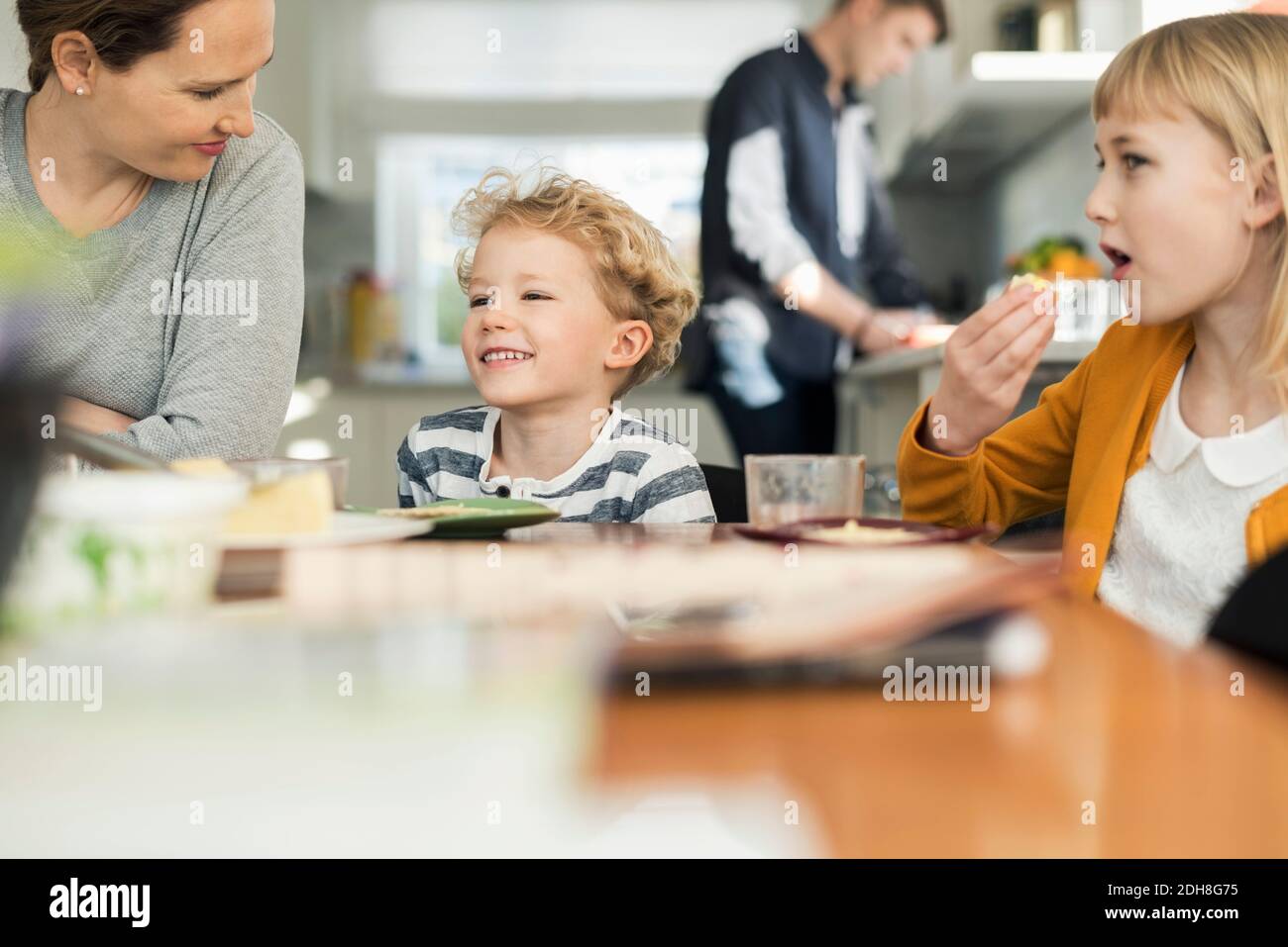 Happy family eating breakfast at home Stock Photo