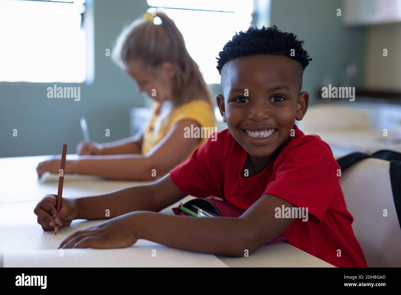 Schoolboy sitting at a desk in an elementary school classroom Stock ...