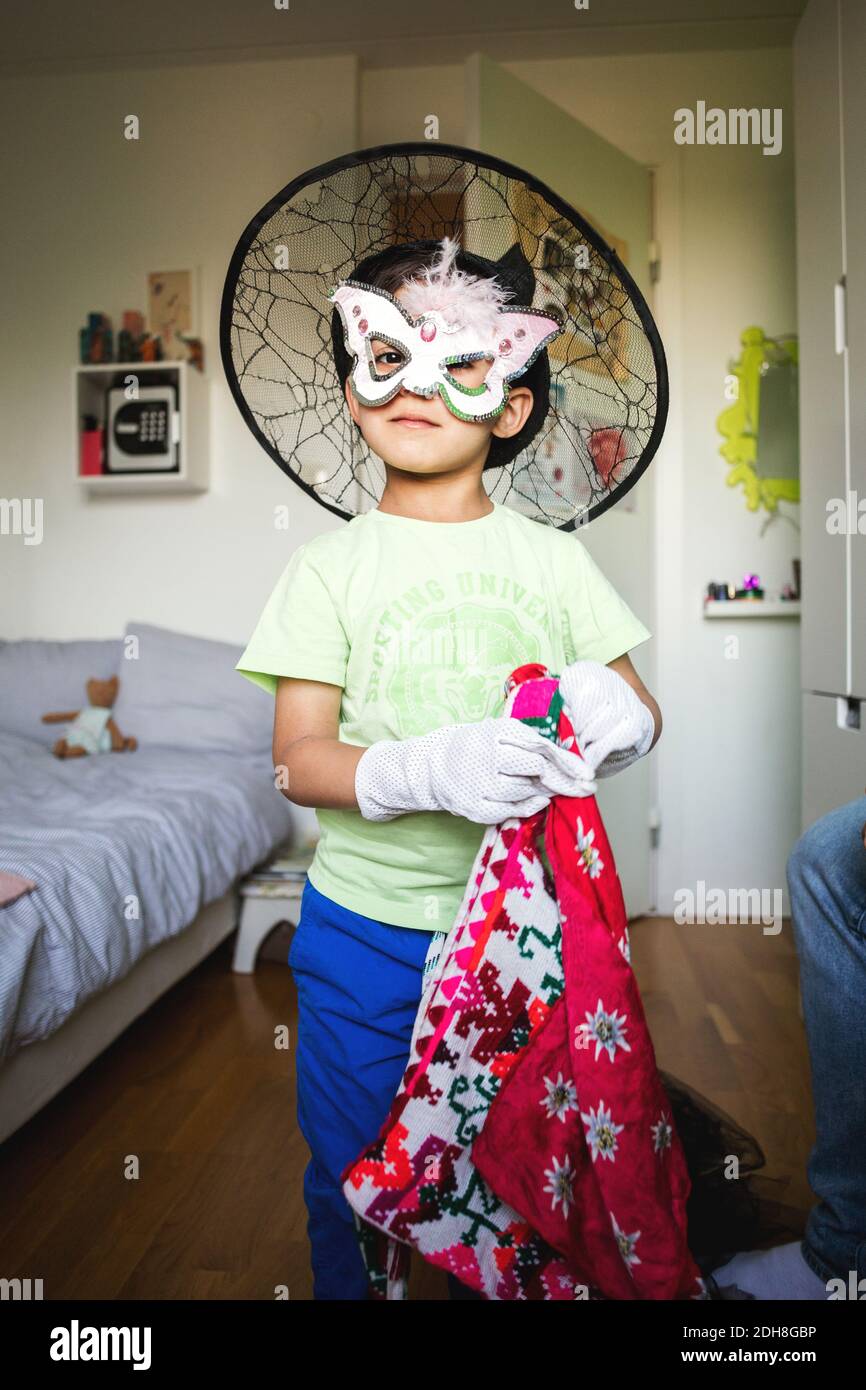 Portrait of confident boy in costume standing at home Stock Photo