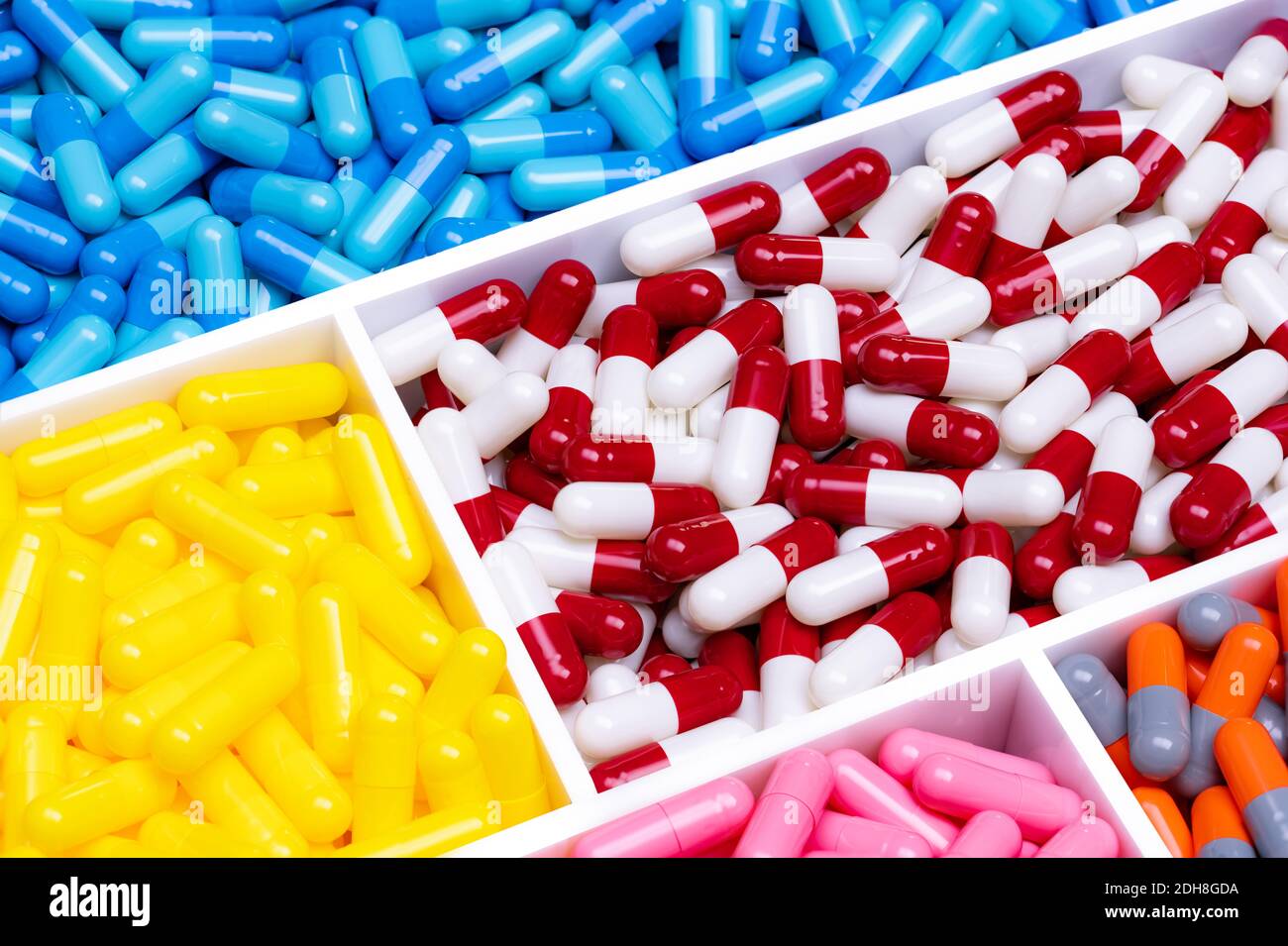 Top view of colorful capsule pills in plastic tray. Pharmaceutical industry. Healthcare and medicine. Pharmaceutics concept. Vitamins and supplements Stock Photo