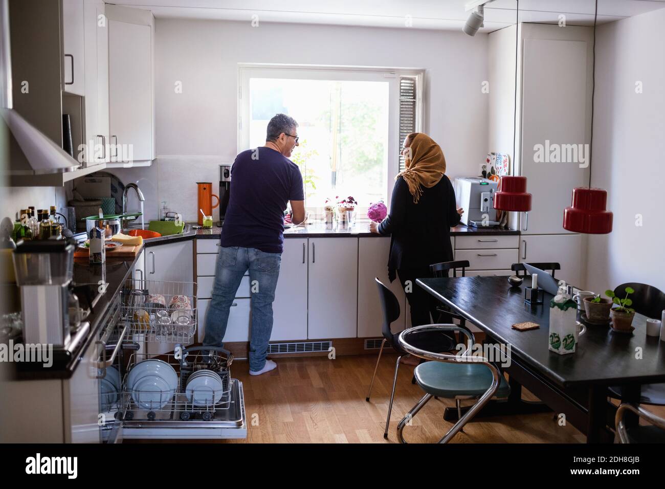 Couple standing in kitchen hi-res stock photography and images - Alamy