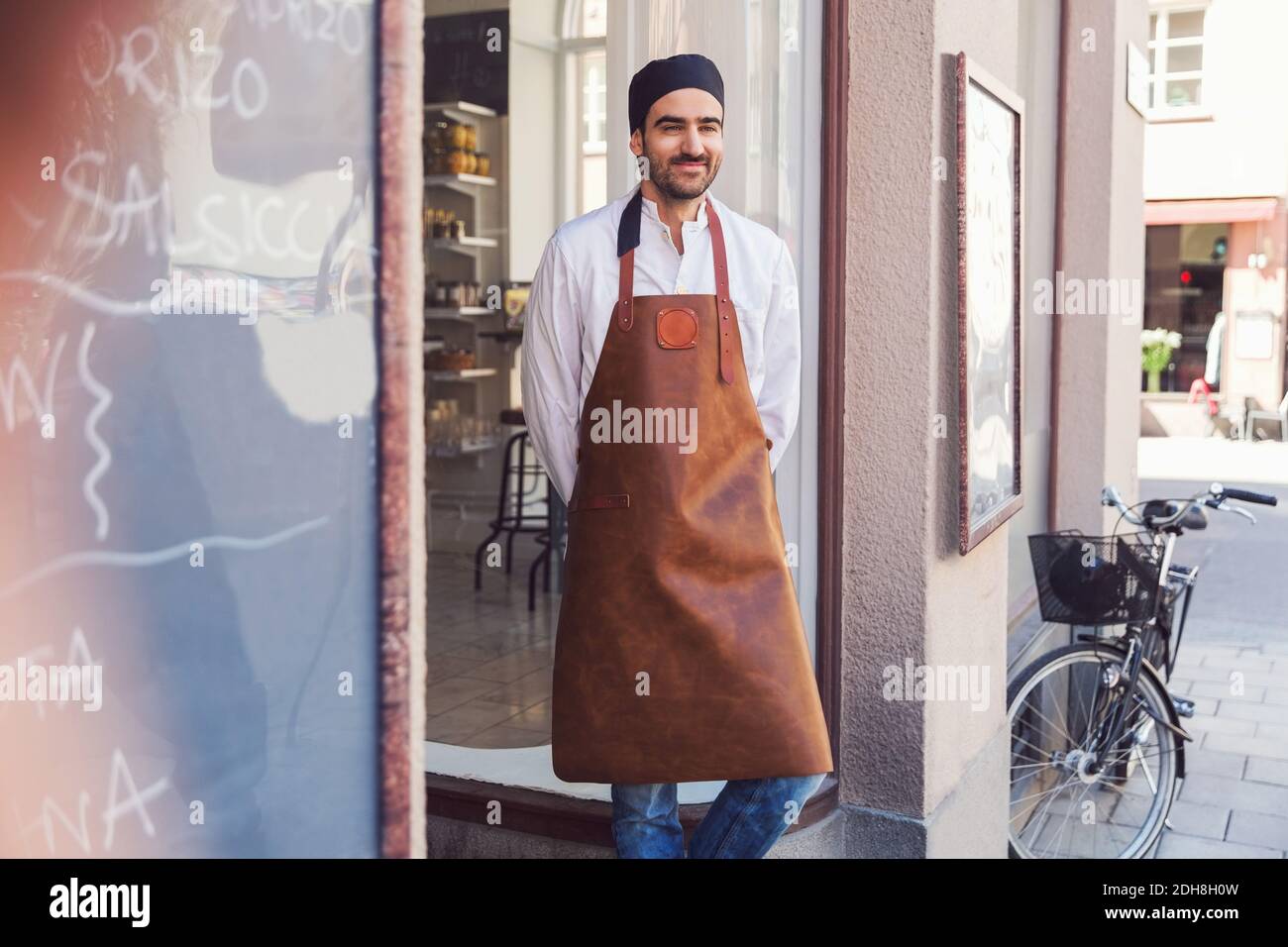 Thoughtful male owner standing outside grocery store Stock Photo Alamy