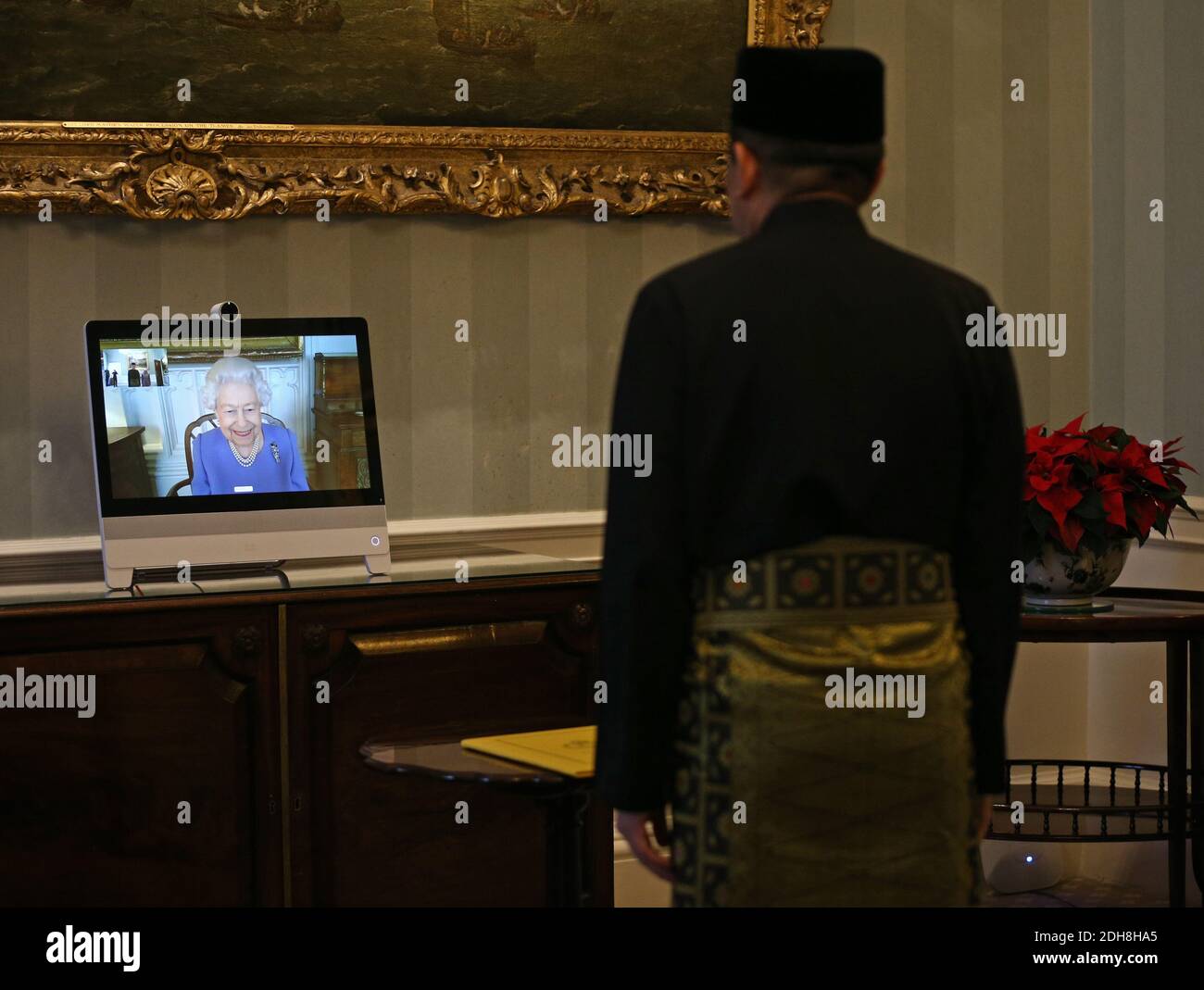 Queen Elizabeth II appears on a screen by videolink from Windsor Castle, where she is in residence, during a virtual audience to receive His Excellency the High Commissioner for Brunei Darussalam First Admiral Pengiran Dato Seri Pahlawan Norazmi bin Pengiran Haji Muhammad, who was at London's Buckingham Palace. Stock Photo
