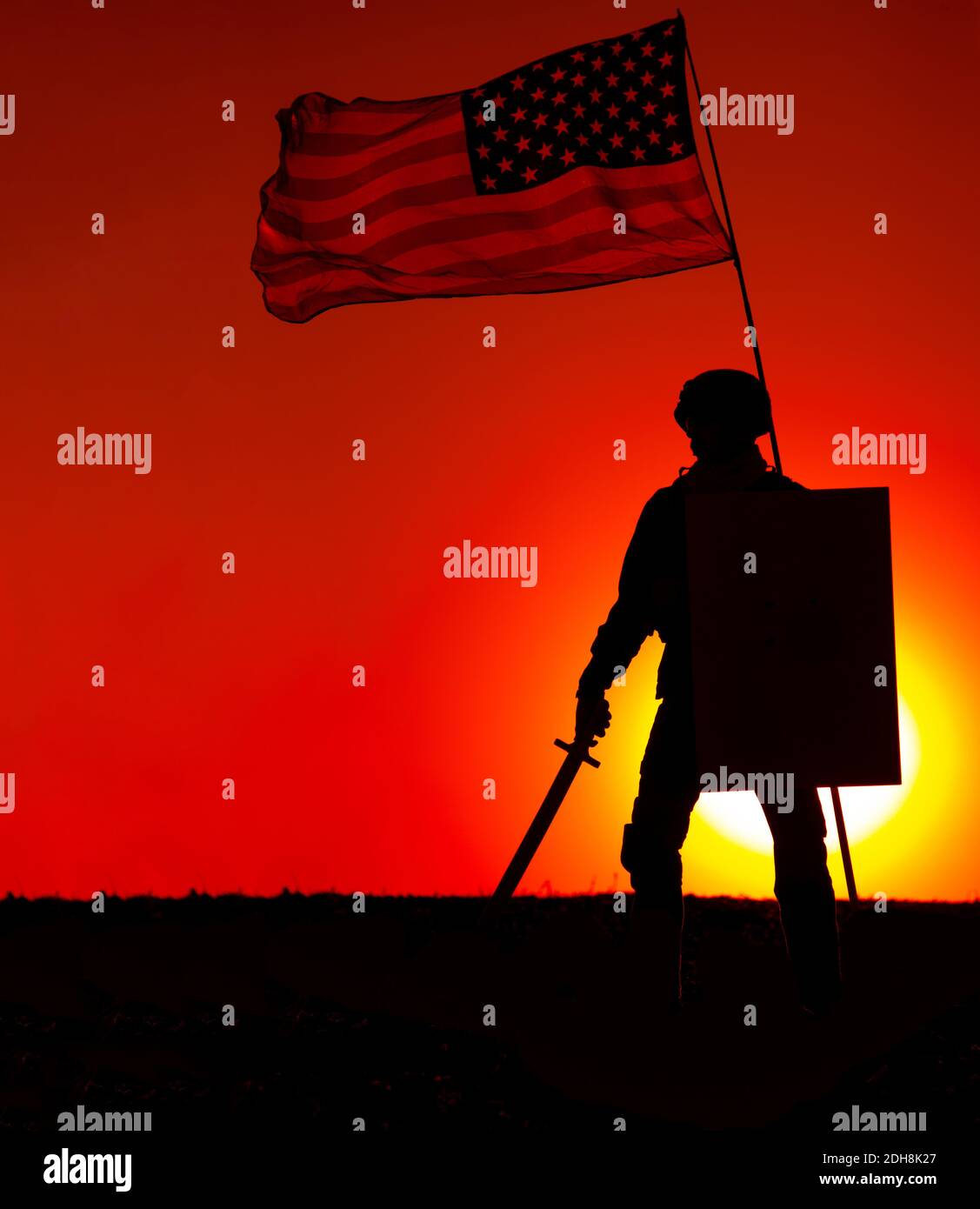 Silhouette of American army soldier armed sword and shield standing under waving US national flag on background of sunset. Army hero and patriot, military glory and honor, fallen soldiers remembrance Stock Photo