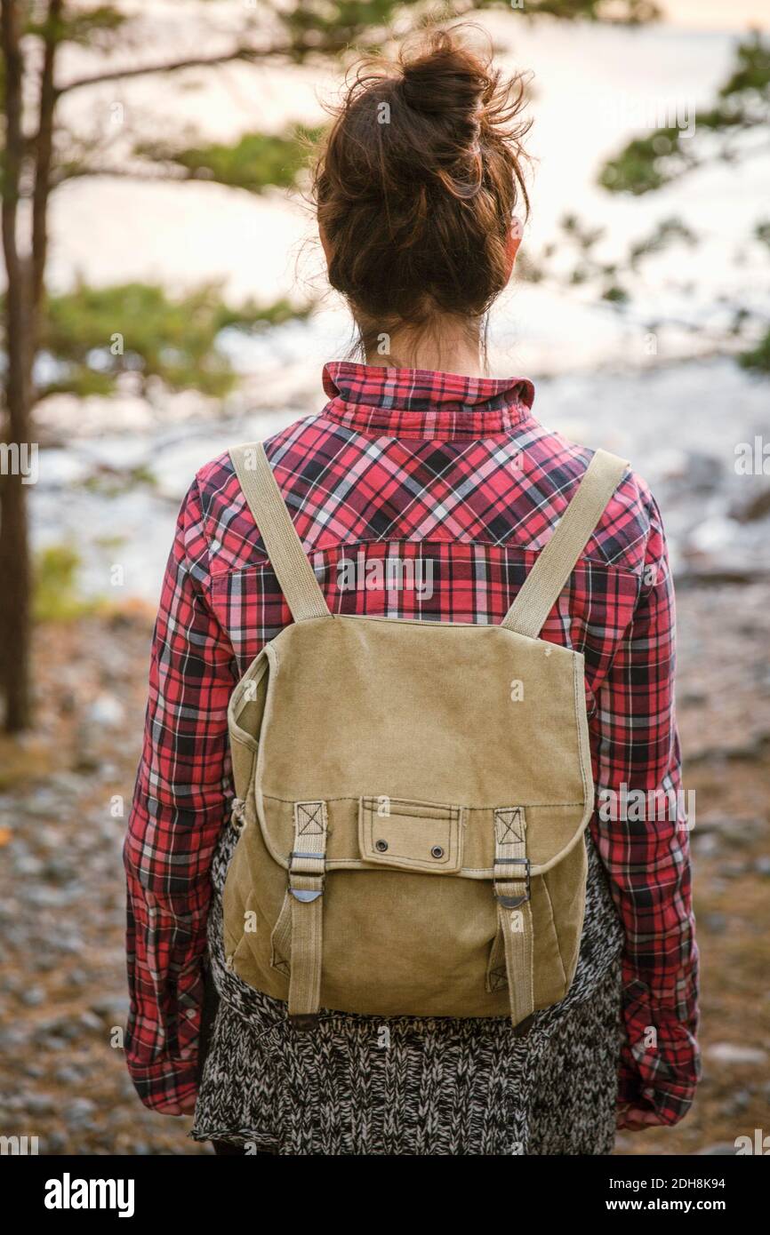 Rear view of woman hiking in forest Stock Photo - Alamy