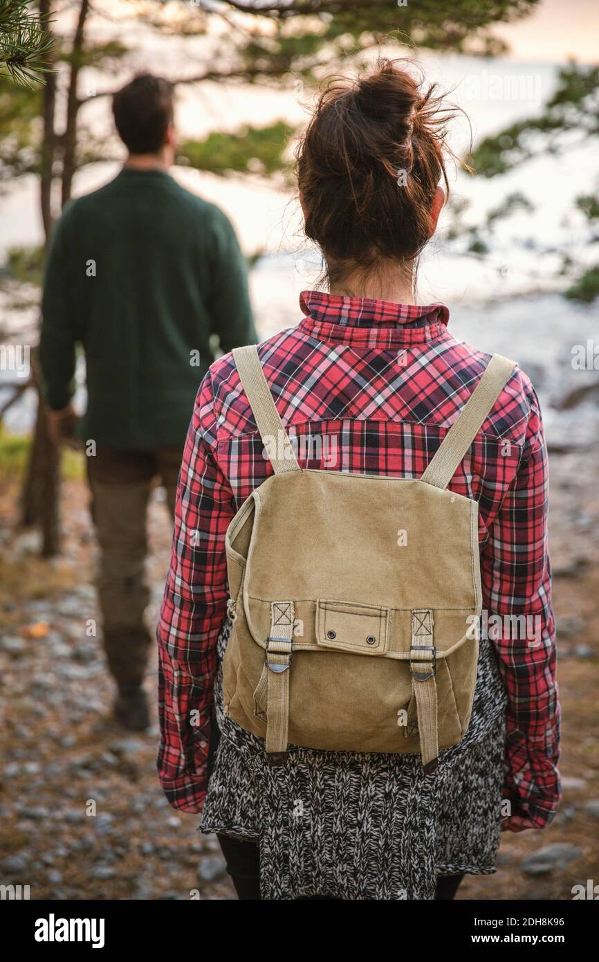 Rear view of couple hiking in forest Stock Photo