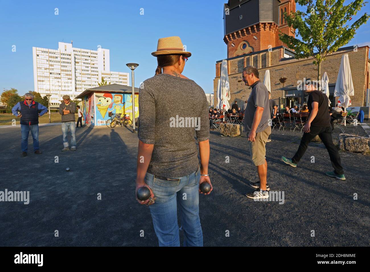 People playing bowls in summer sunshine, in front of the Old Water Tower, Wiesbaden Germany . Stock Photo