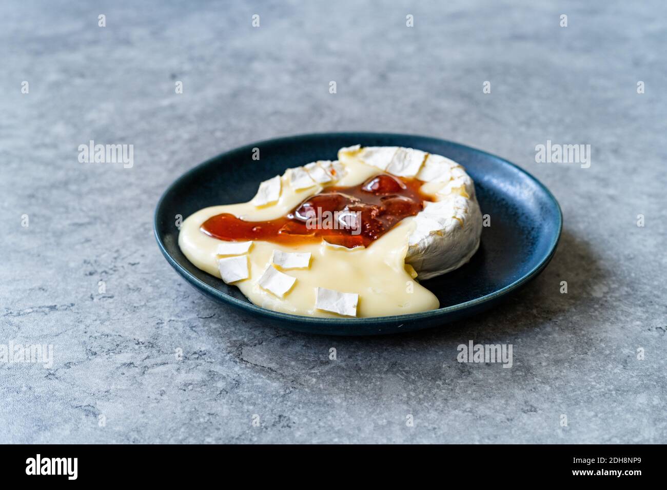 Baked Brie Cheese Dessert with Strawberry Jam. Marmalade Melted