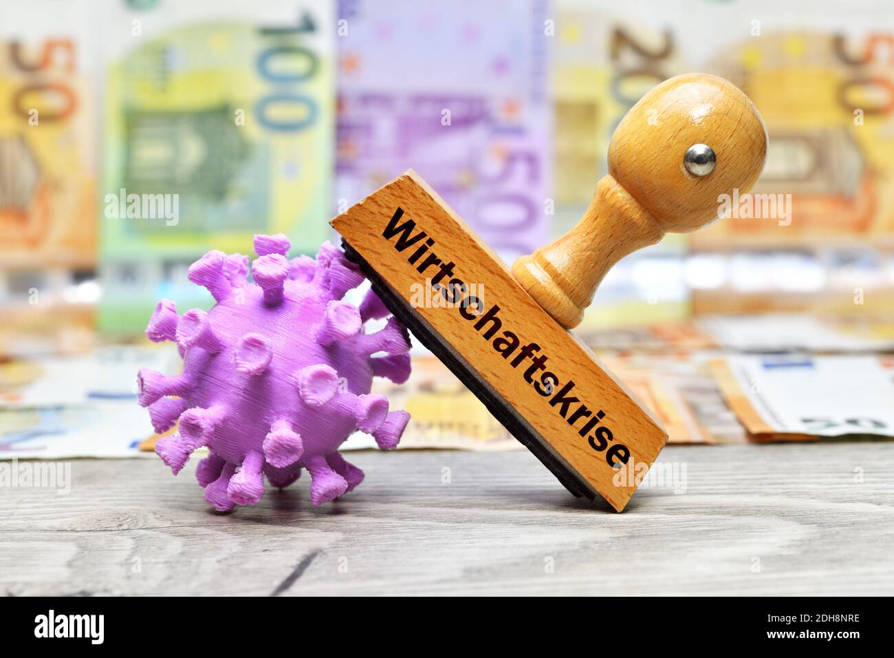 The German Word For Economic Crisis On Stamp With Coronavirus Model Stock Photo