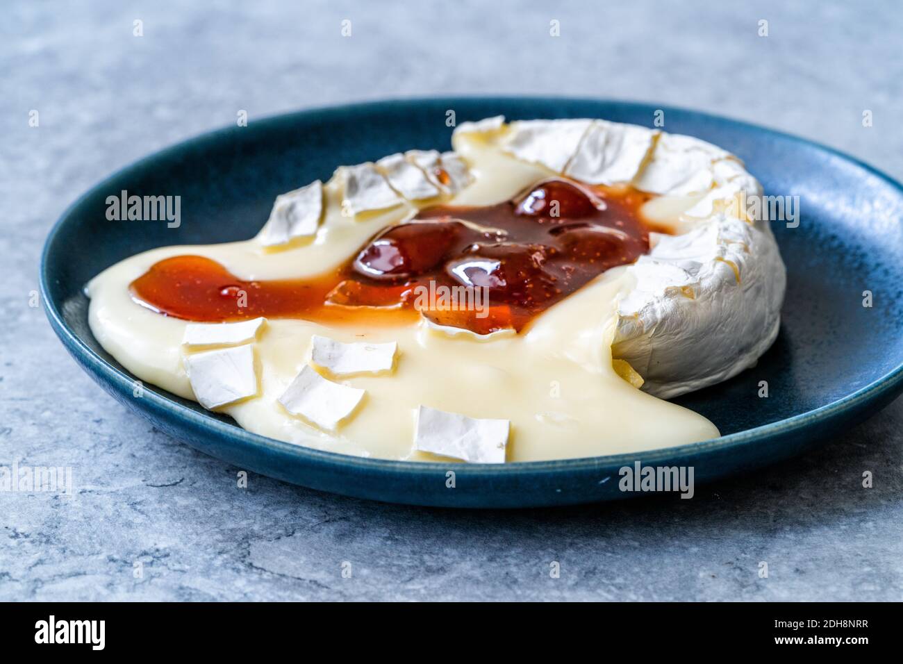 Baked Brie Cheese Dessert with Strawberry Jam. Marmalade Melted