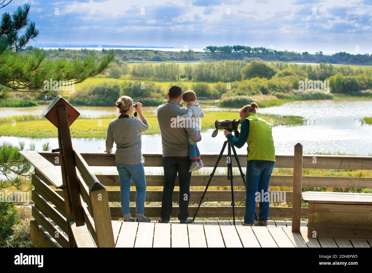 Somme Bay (northern France): bird watching outing in the bird sanctuary “Parc du Marquenterre”, in Saint-Quentin-en-Tourmont. Family and guide on an o Stock Photo