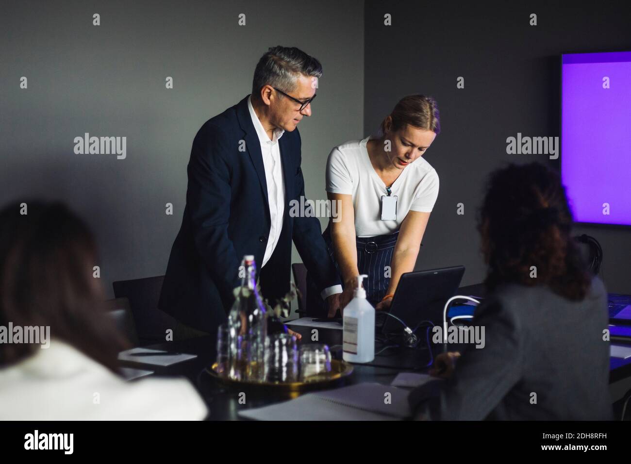 Female coworker using laptop male hi-res stock photography and images ...
