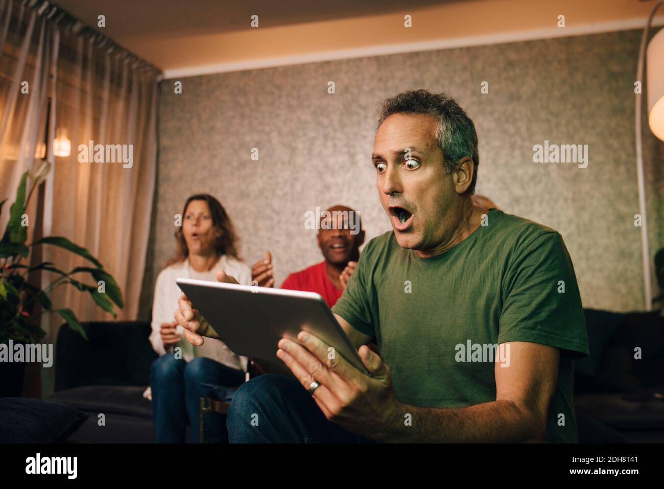 Disappointed and shocked man using digital tablet during sporting event Stock Photo