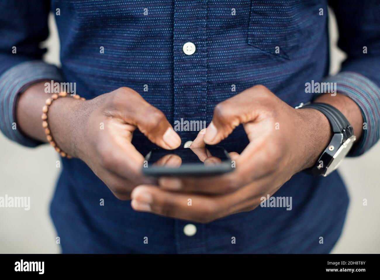 Midsection of man using mobile phone Stock Photo