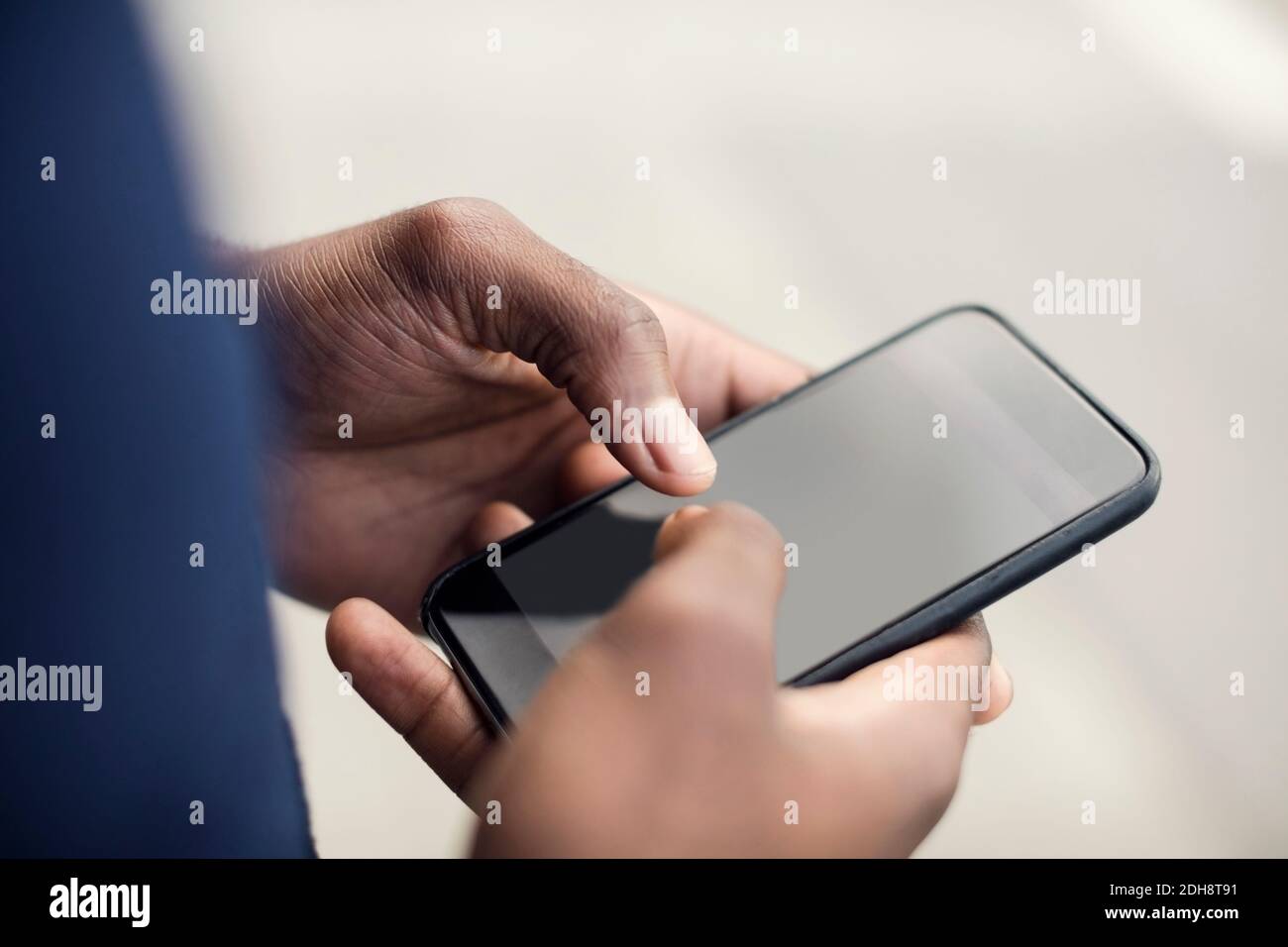 Cropped image of man using mobile phone Stock Photo