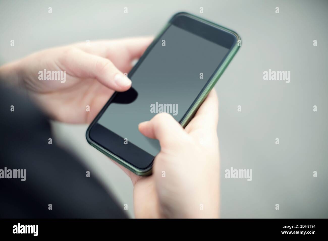 Cropped image of woman using smart phone Stock Photo