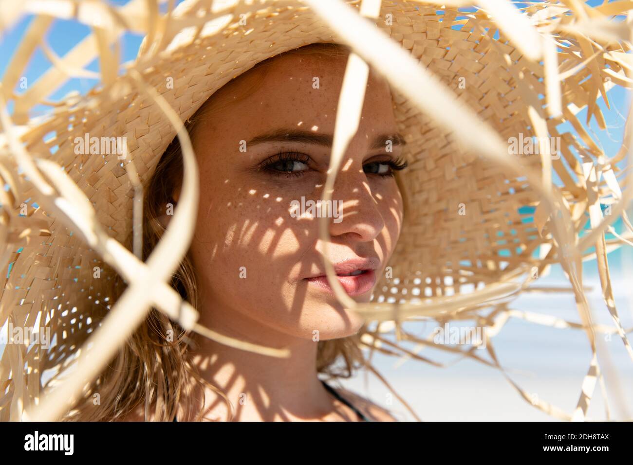 Young woman with straw hat at the beach Stock Photo - Alamy