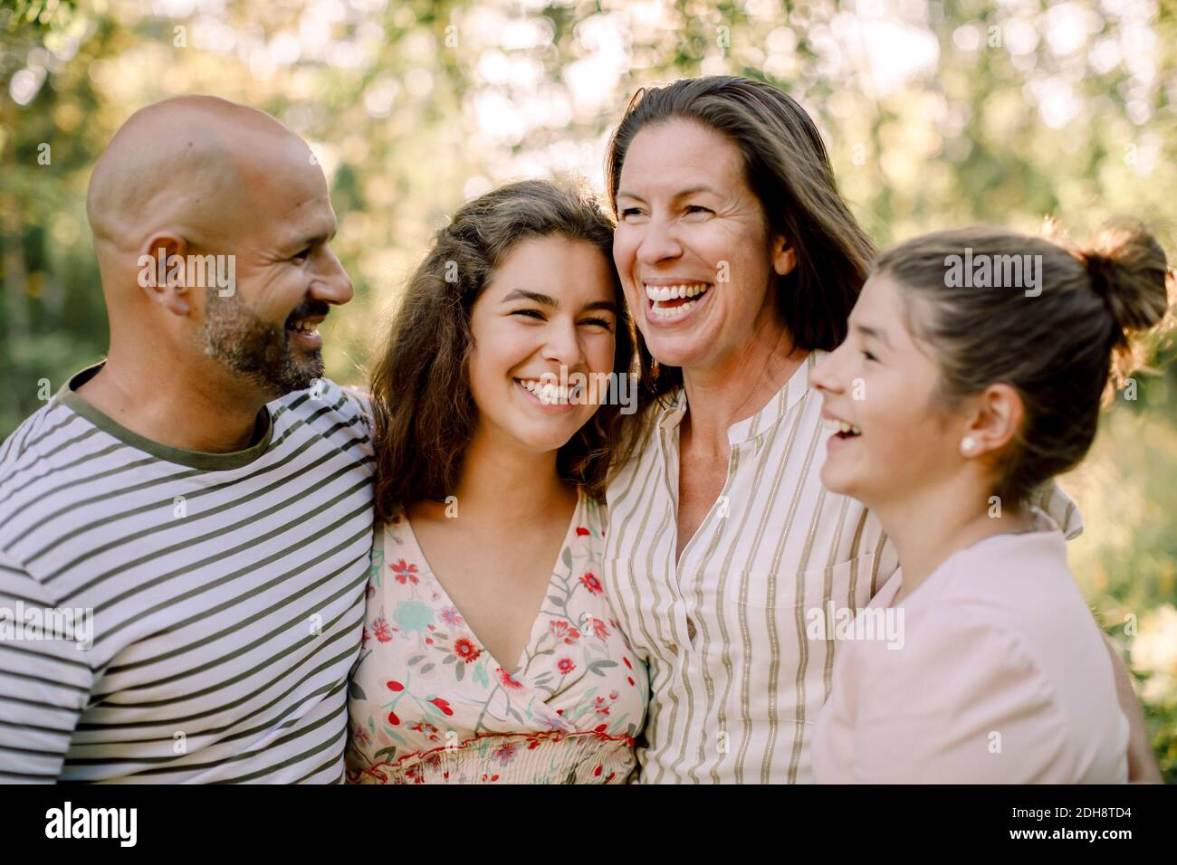 Smiling family spending time together while enjoying in yard during summer Stock Photo