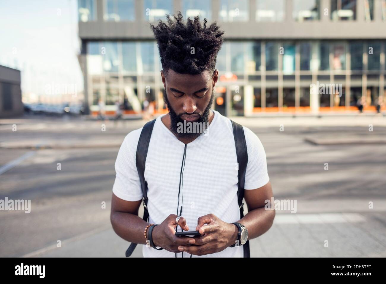 Young man using phone while in city Stock Photo