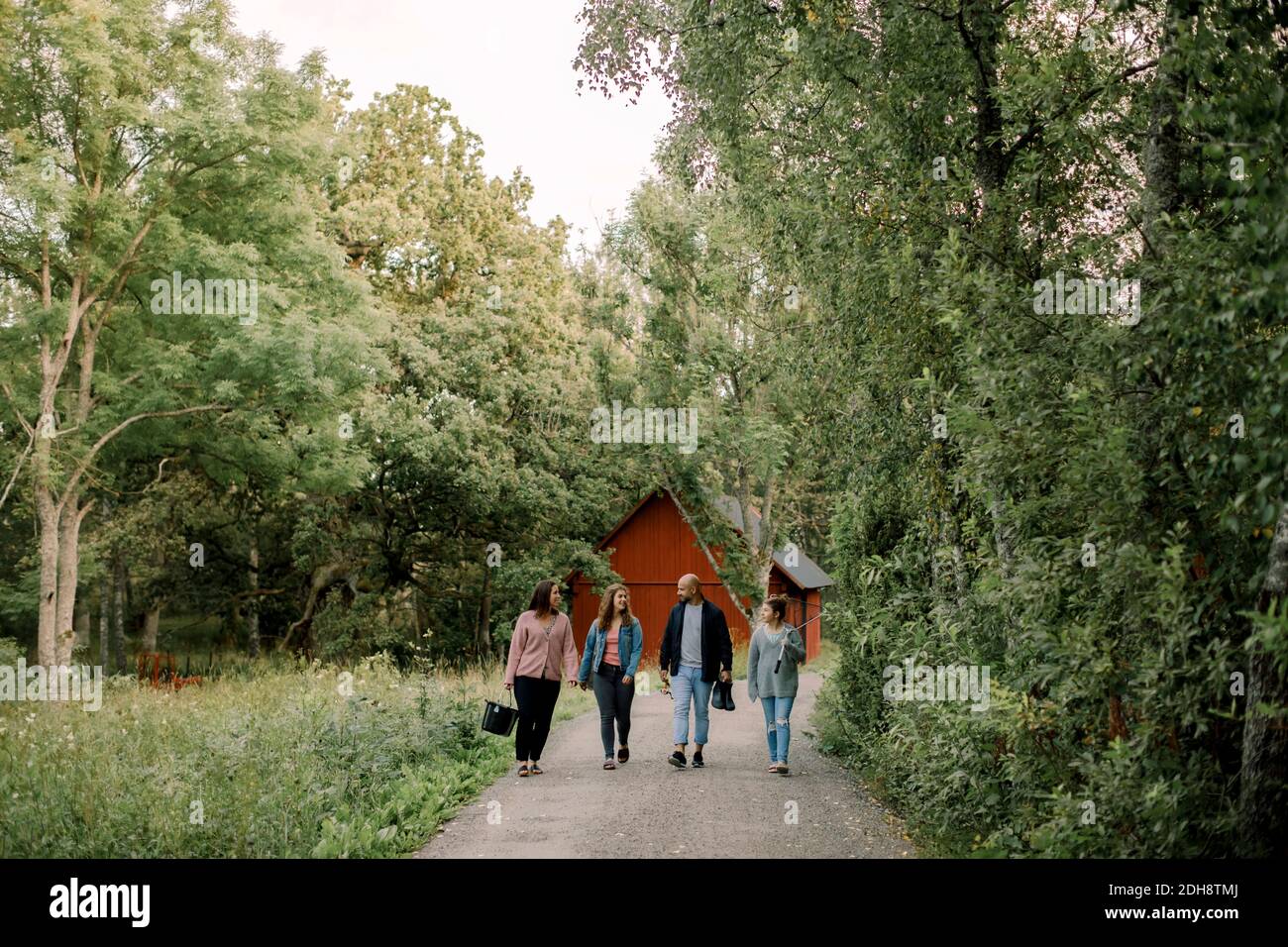 Parents with daughters walking on footpath during vacations Stock Photo