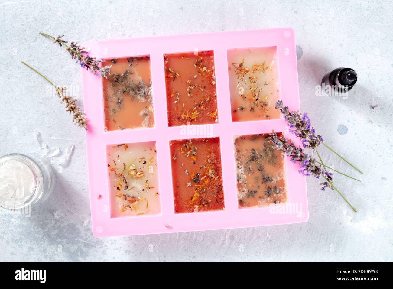 The process of making handmade soap. Glycerin with herbs, poured into a special mold for drying