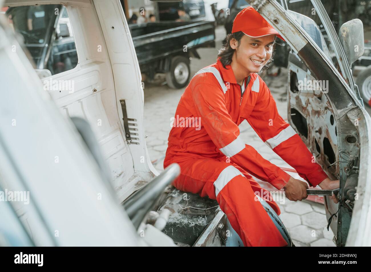 portrait of young asian man repairing a broken car engine part Stock ...