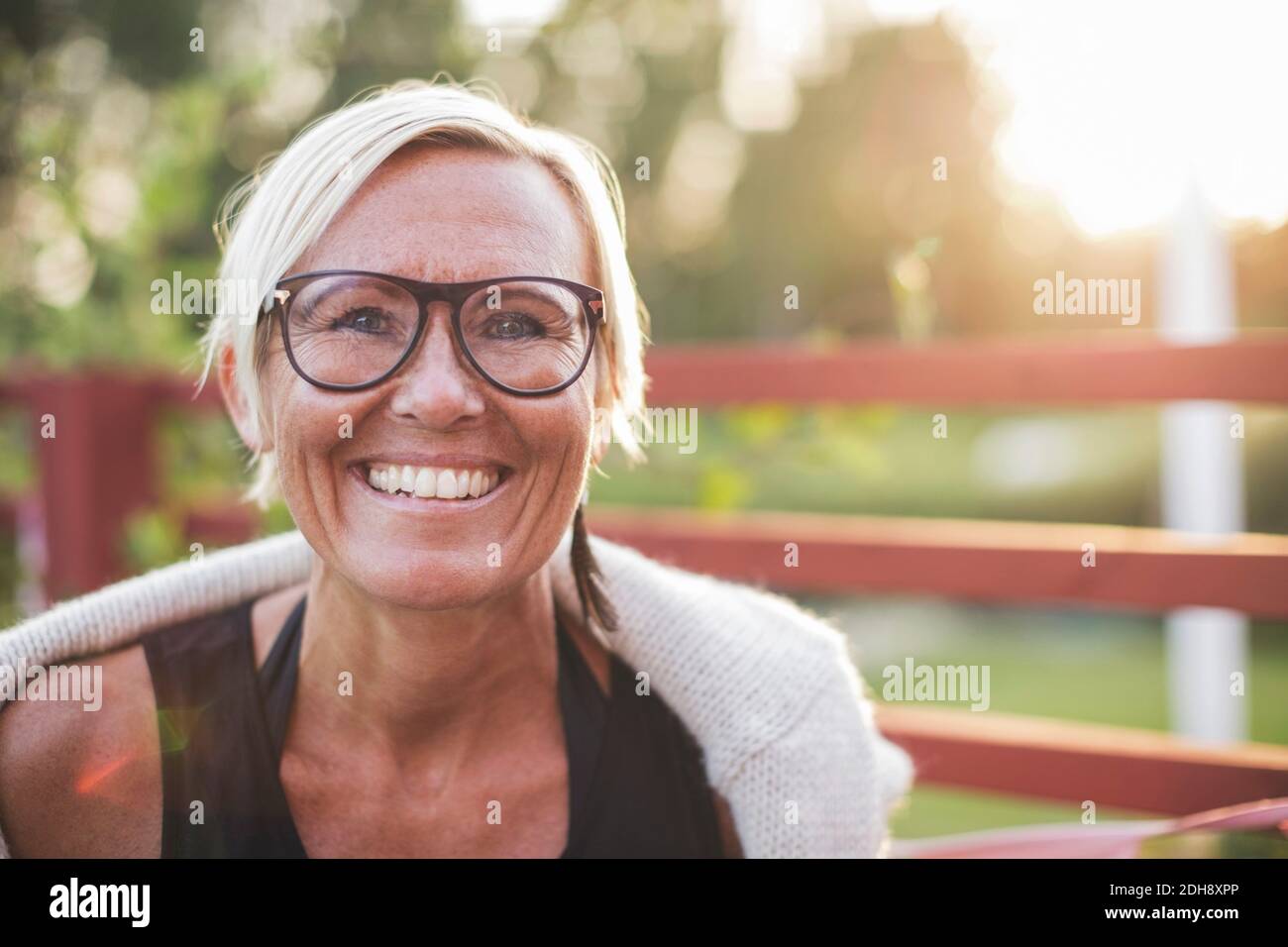 Portrait of happy mature woman in back yard Stock Photo