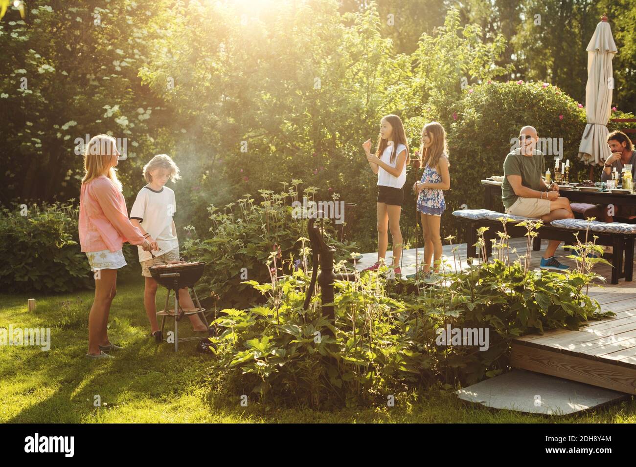 People enjoying summer during garden party on sunny day Stock Photo