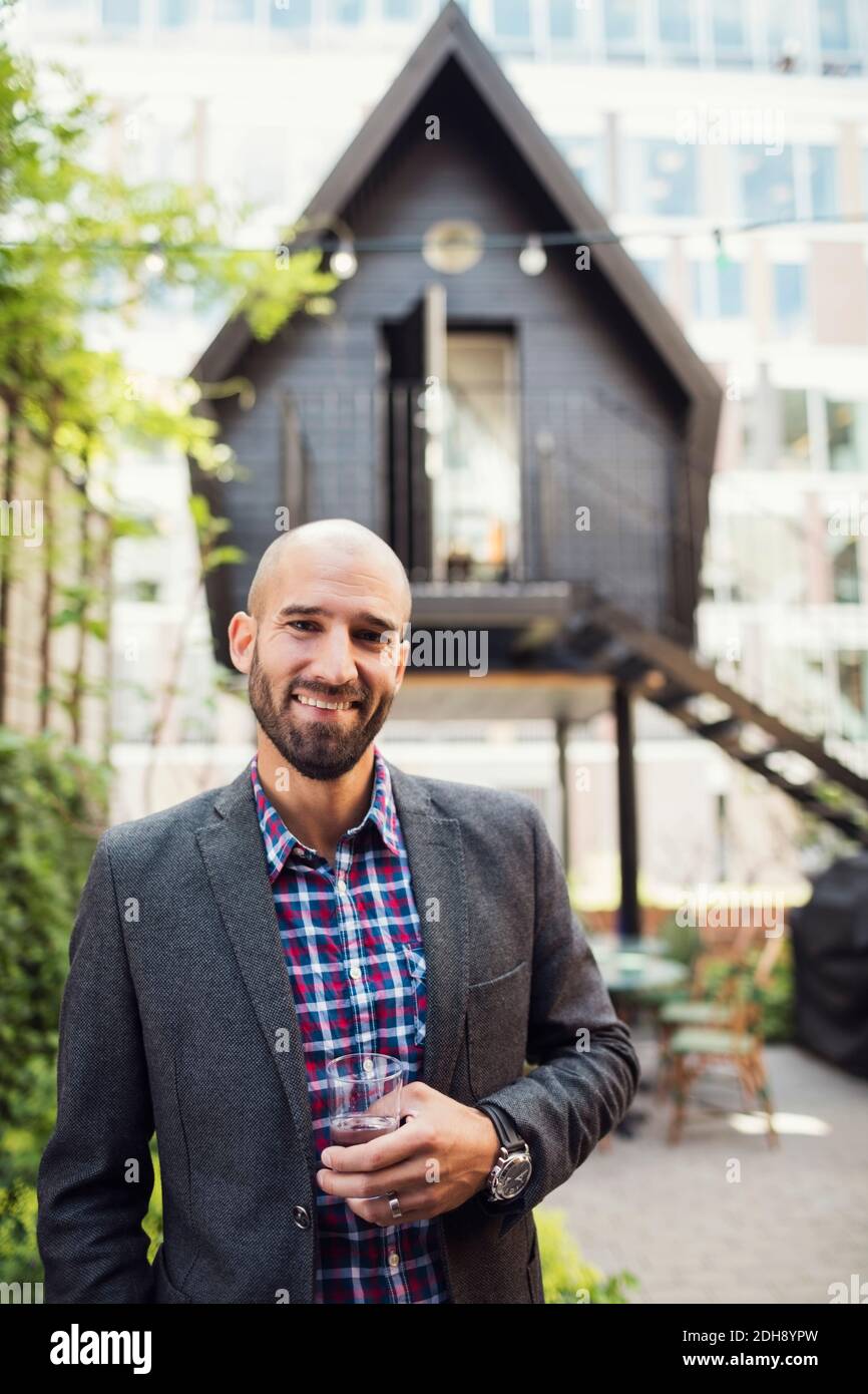 Portrait of confident businessman standing at office yard Stock Photo