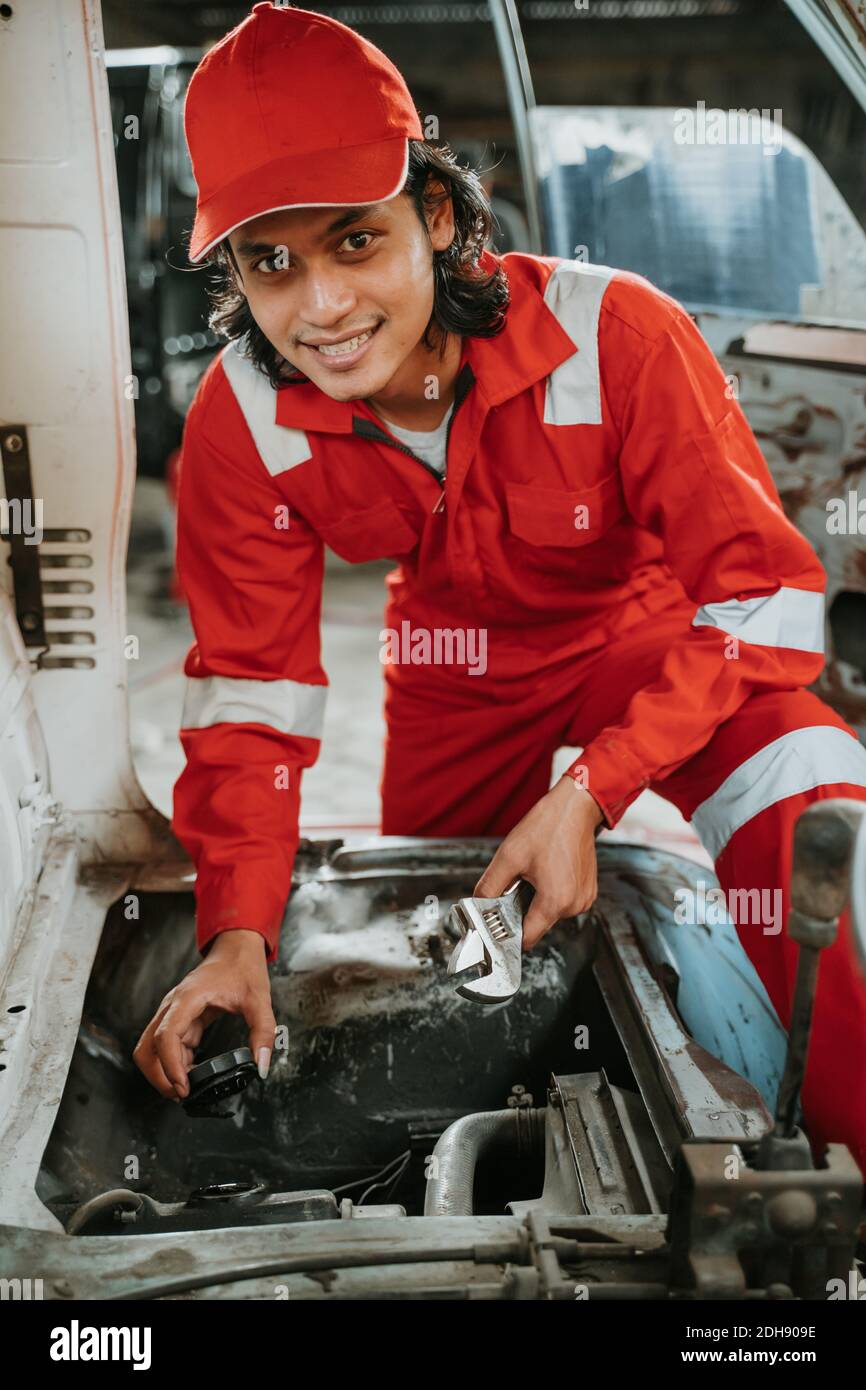 portrait of young asian man repairing a broken car engine part Stock ...