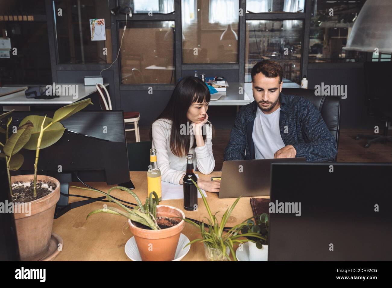 High angle view of colleagues discussing at workplace Stock Photo