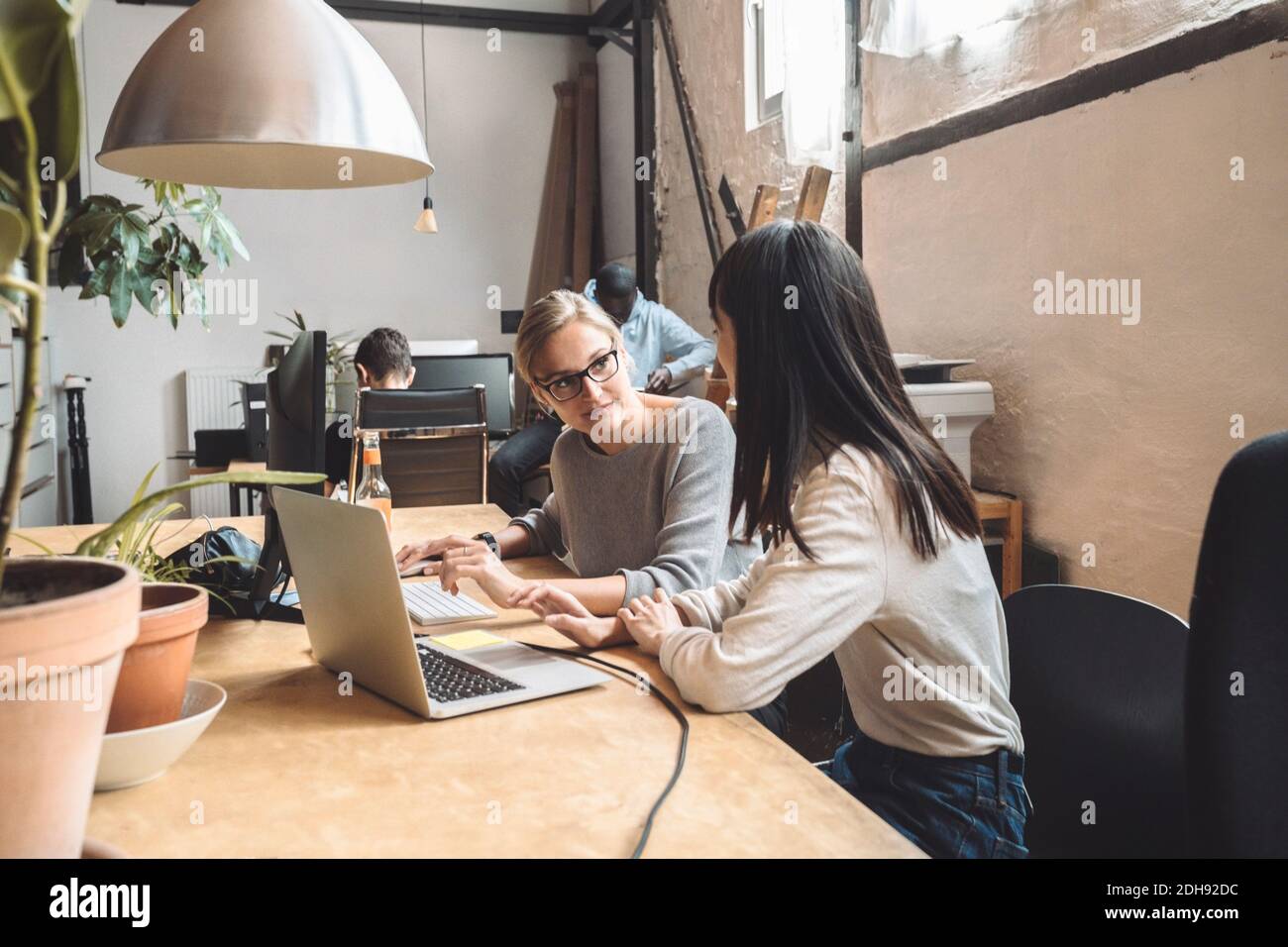 Female computer programmers discussing at place of work Stock Photo