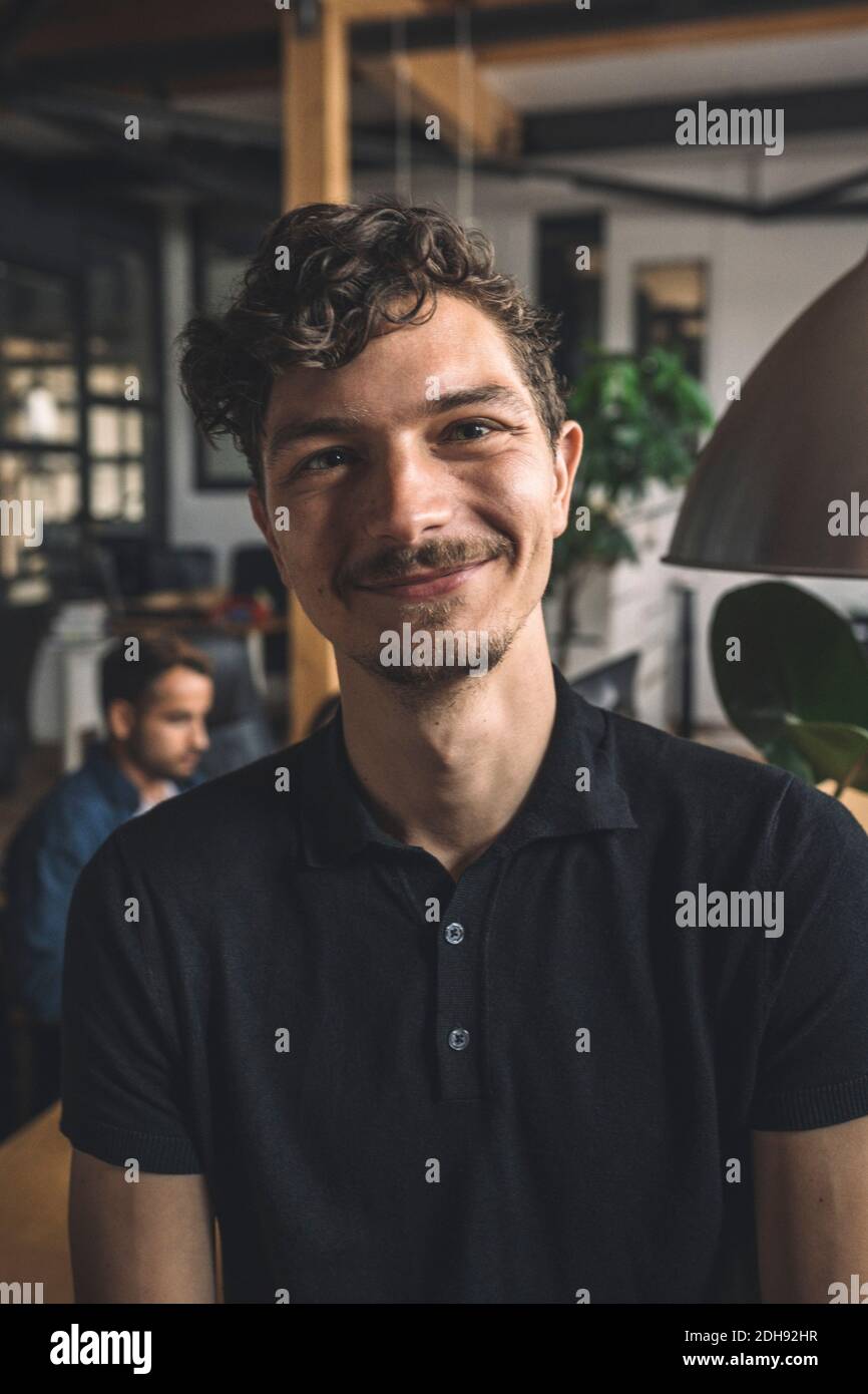 Portrait of smiling computer programmer at workplace Stock Photo