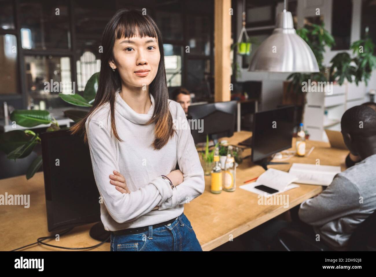 Smiling asian businesswoman arms hi-res stock photography and images ...