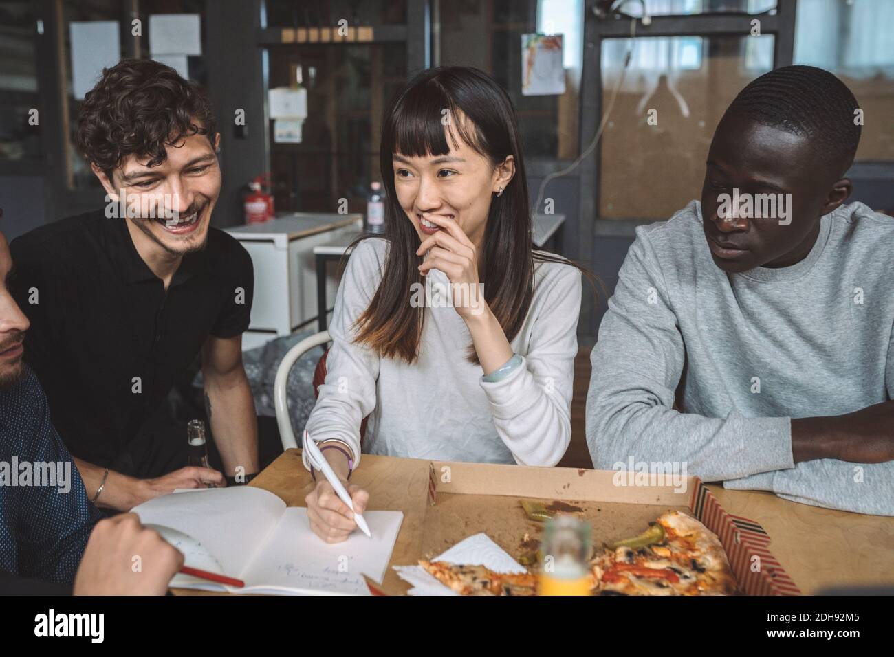 Smiling business partners working at workplace Stock Photo