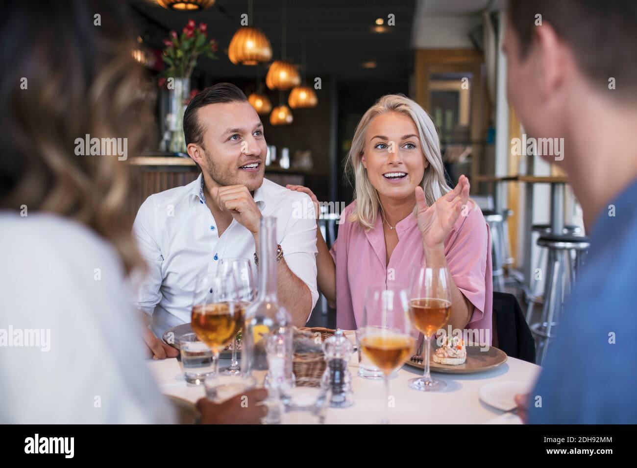 Happy colleagues talking during business lunch meeting at restaurant Stock Photo