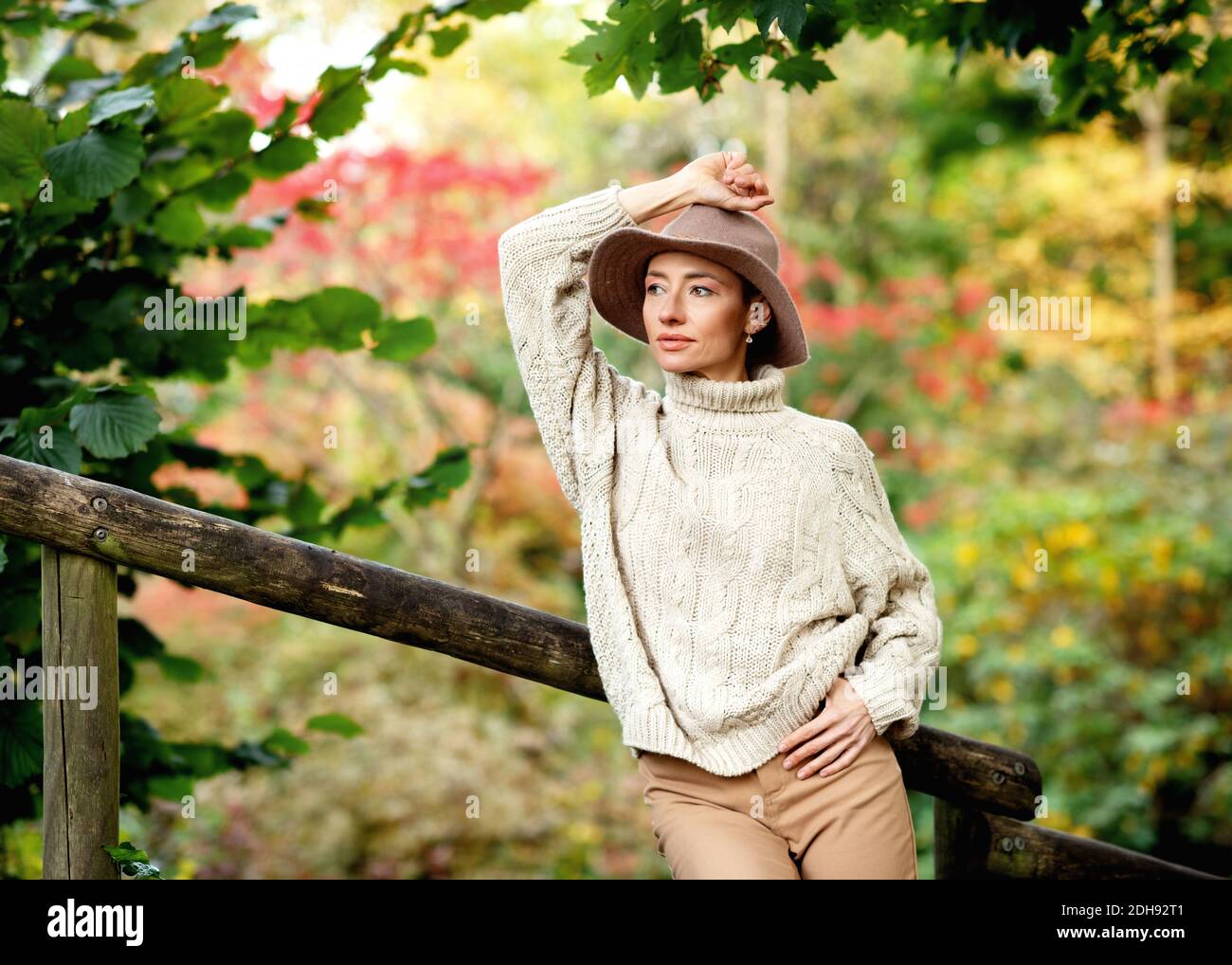 woman in hat walking around the autumn park Stock Photo - Alamy