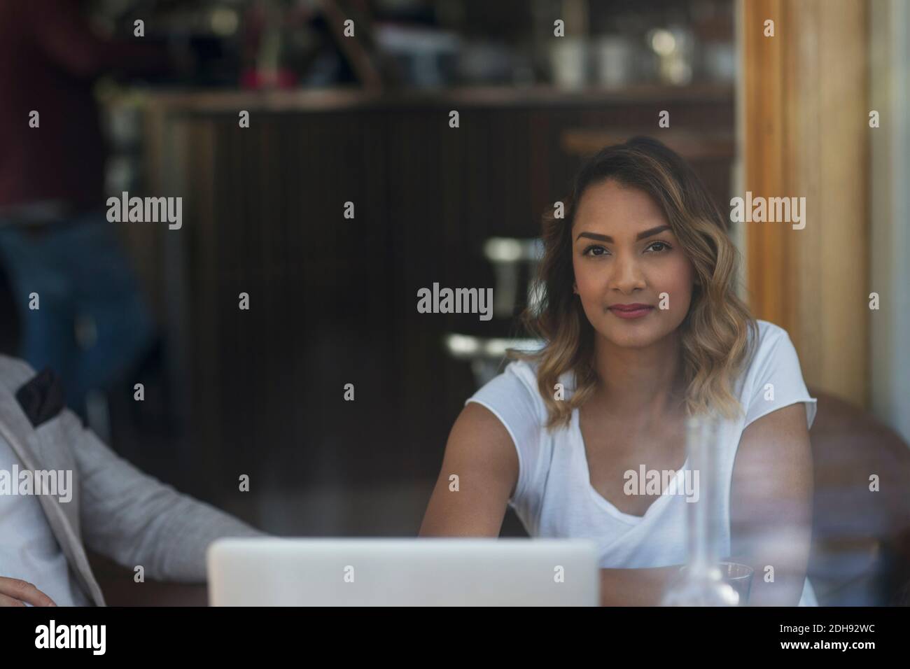 Portrait of confident businesswoman sitting with male colleague at restaurant Stock Photo