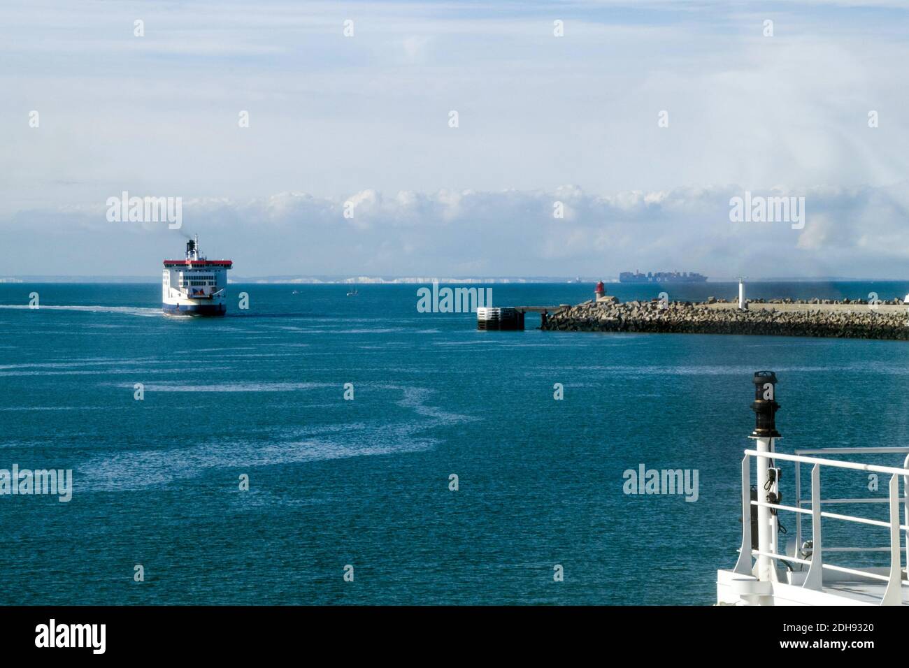 Ferry arriving in the port of Calais with the white cliffs of Dover