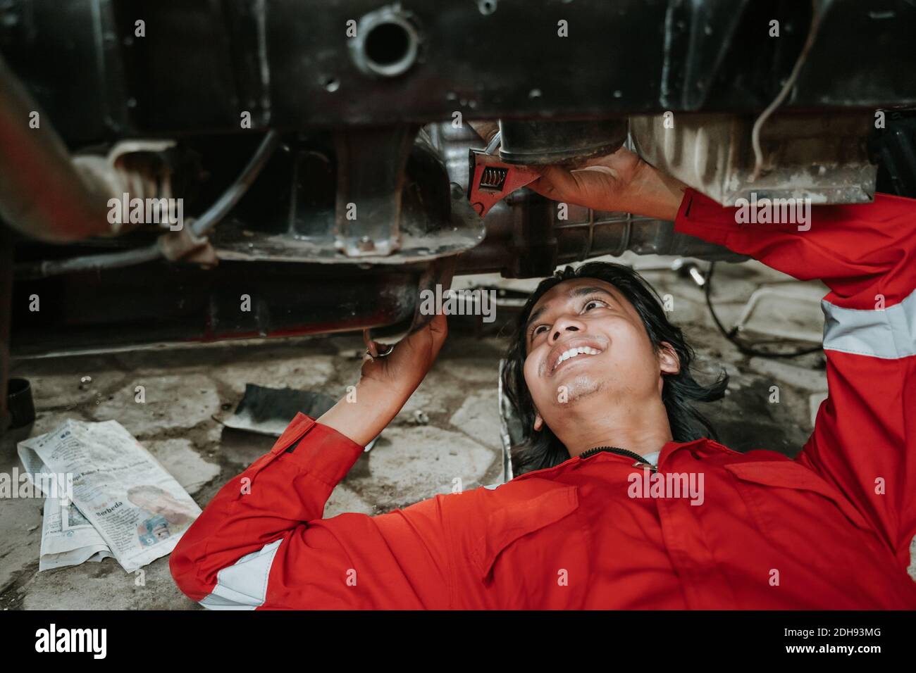 portrait of young asian man repairing a broken car engine part Stock ...
