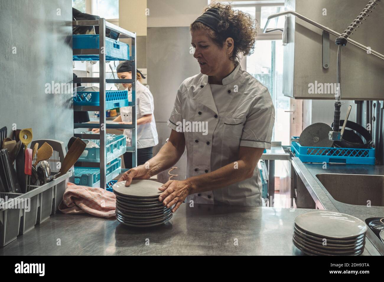 Chef arranging plates on kitchen counter in restaurant Stock Photo Alamy