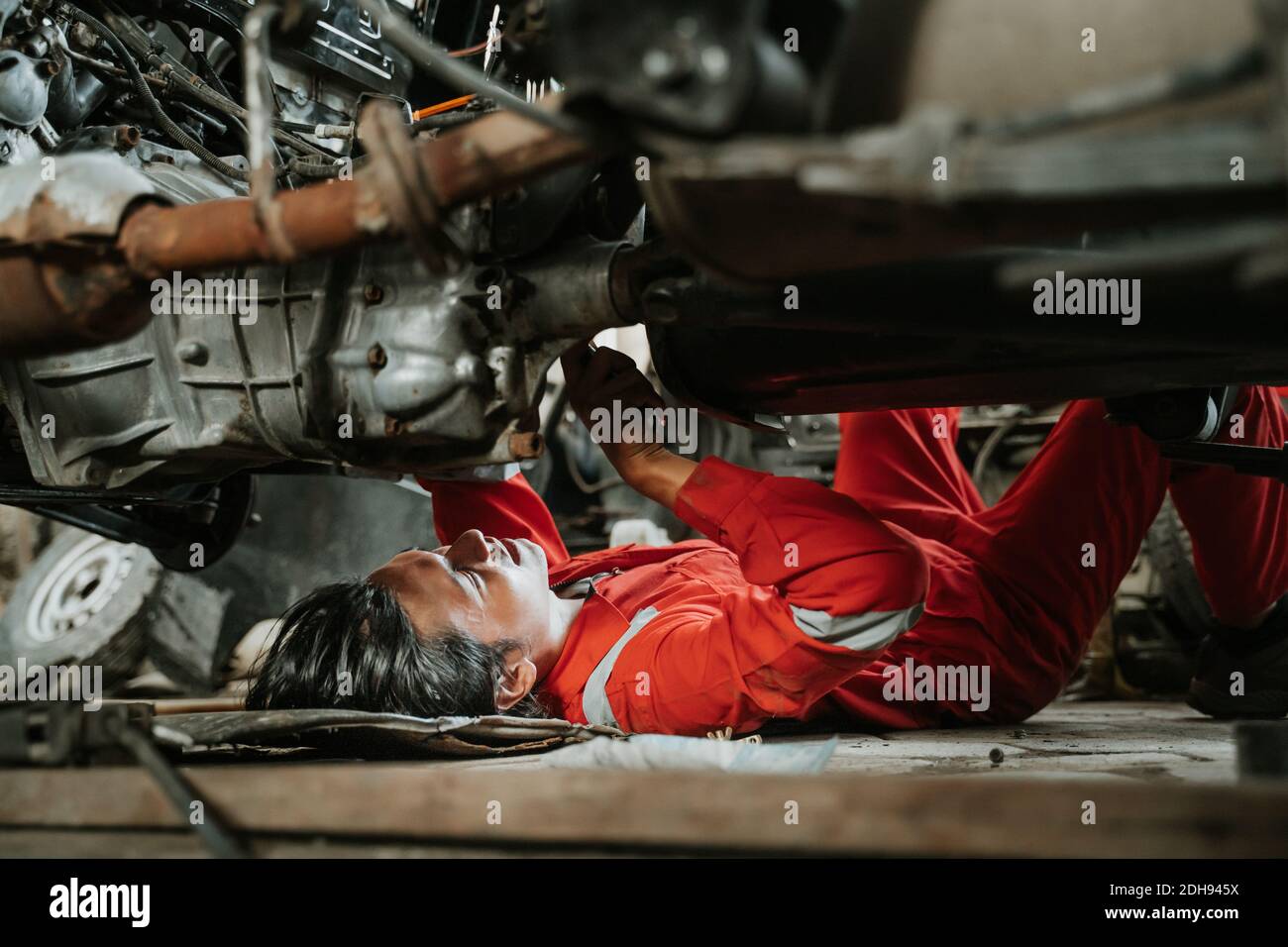 portrait of young asian man repairing a broken car engine part Stock ...