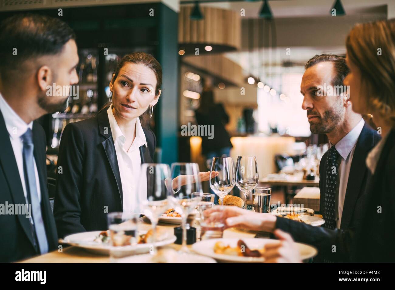 Business coworkers communicating at lunch in restaurant Stock Photo