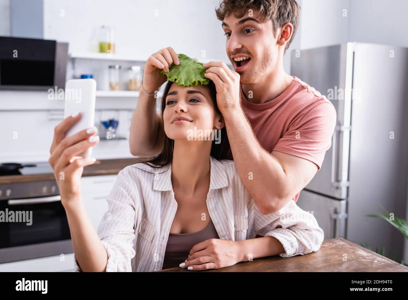 Smiling Man Holding Grater Vegetables Girlfriend Spatula Stove