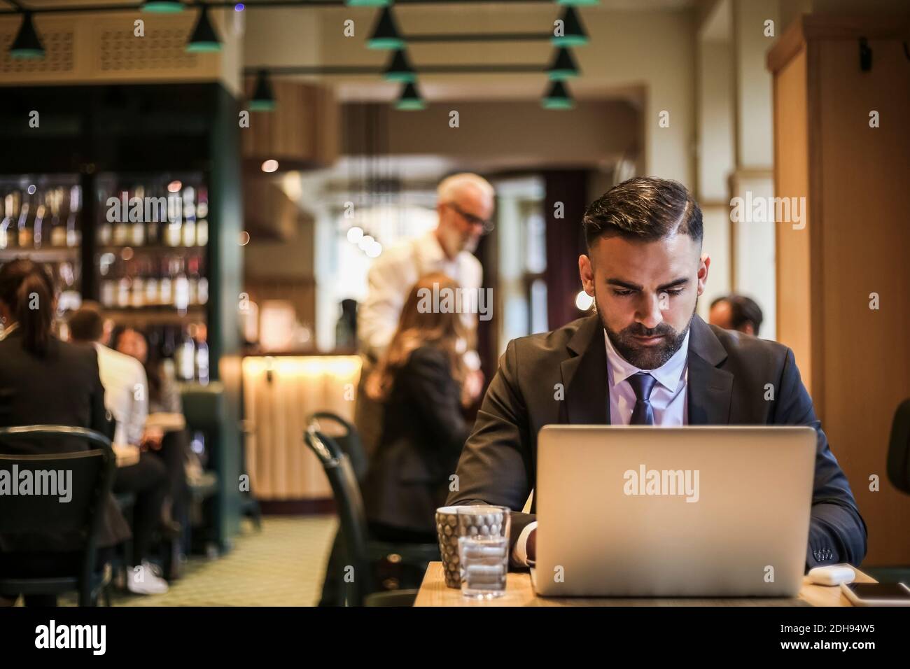 Businessman using laptop in restaurant Stock Photo
